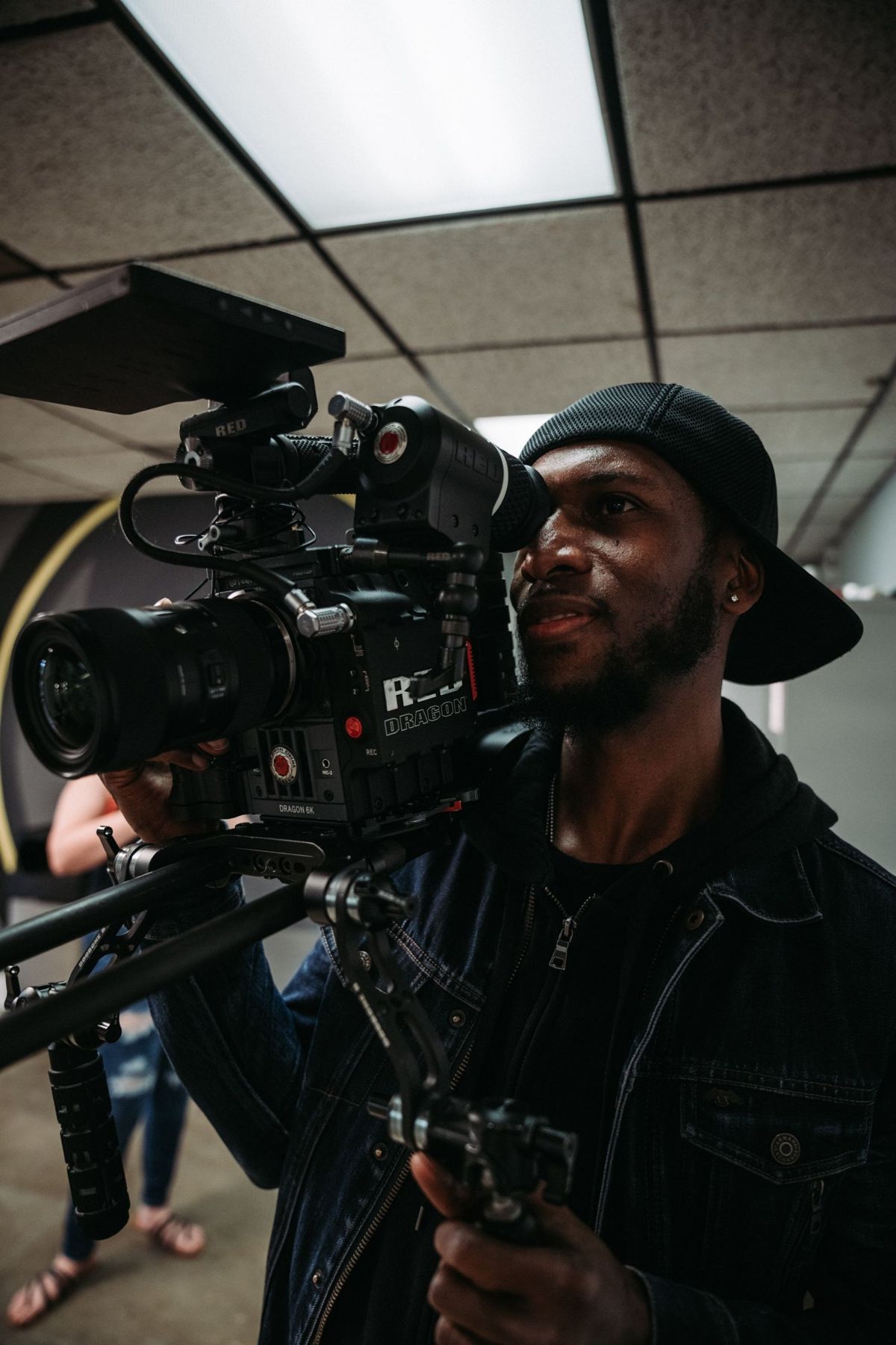 Operator lining up a shot on a RED Dragon camera