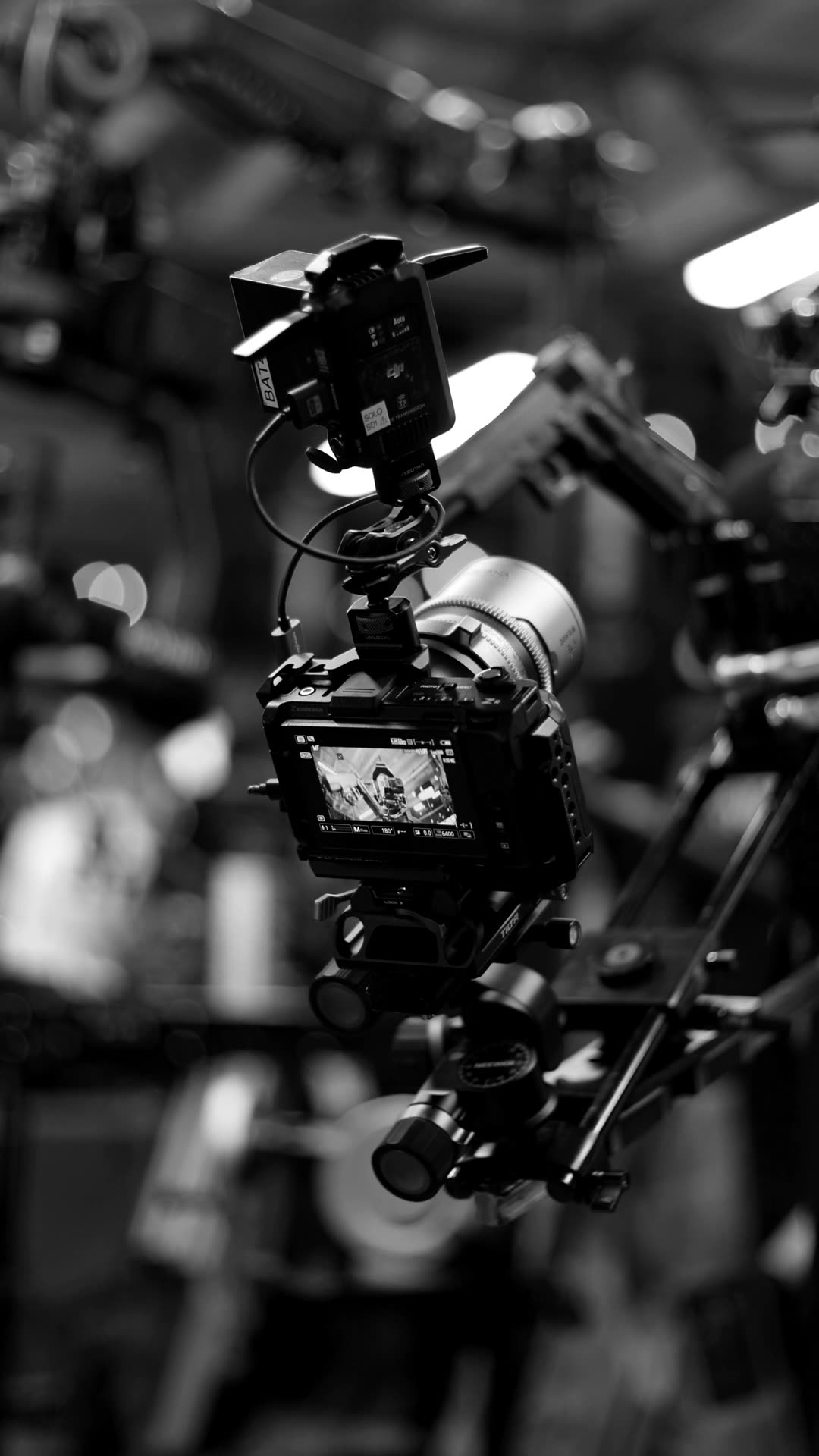 Camera on a crane with its monitor lit