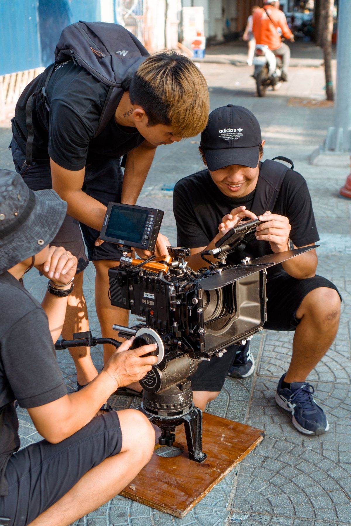 Crew checking a RED camera on a street location